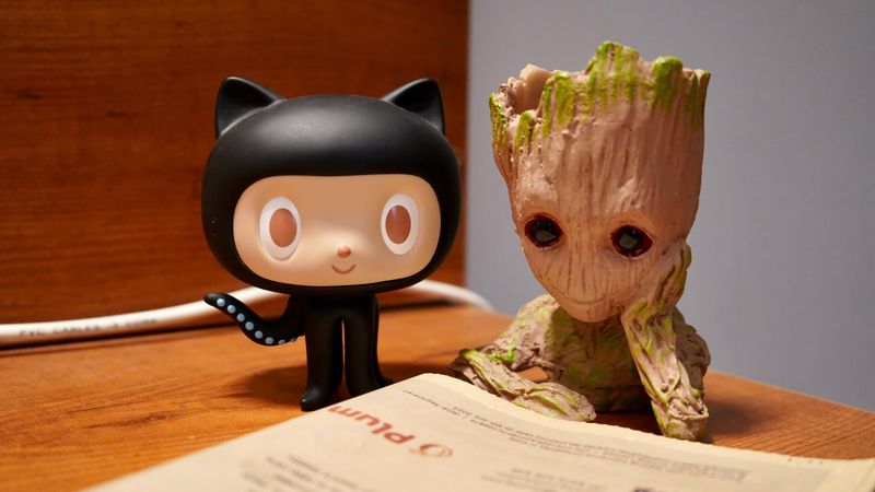 Octocat and Groot reading a book together